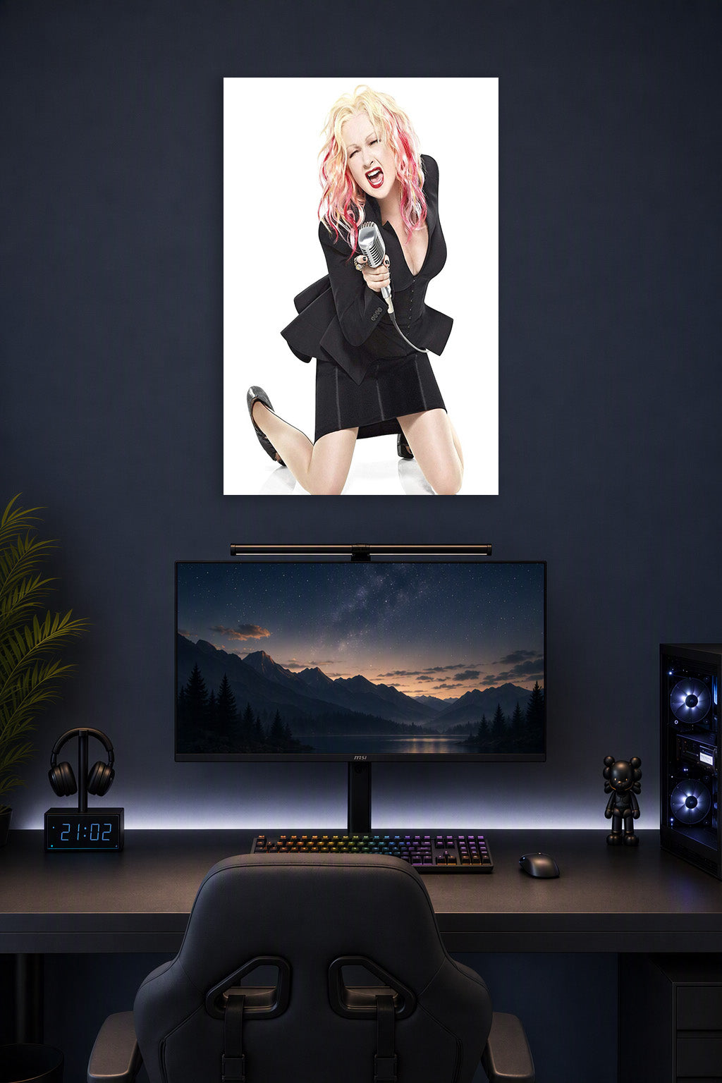Cyndi Lauper in a gaming desk setup above a monitor.