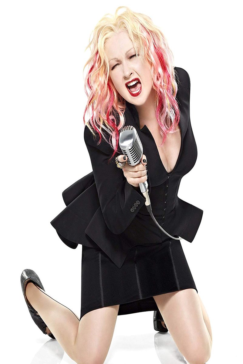 Cyndi Lauper poster features the singer kneeling in black attire, singing into a silver vintage microphone on white.