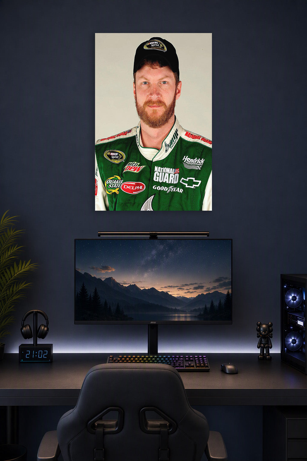 Dale Earnhardt Jr in a gaming desk setup above a monitor.