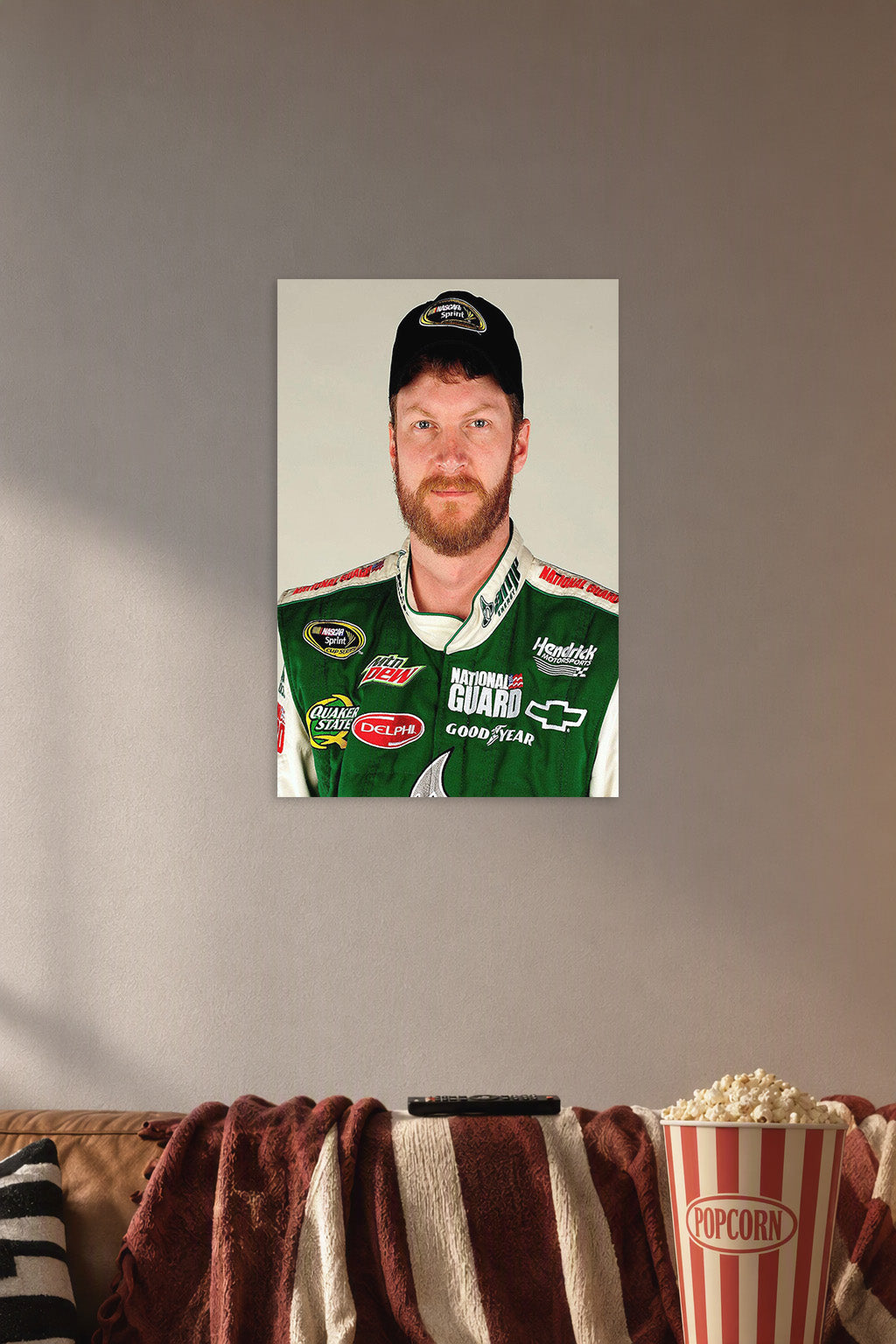 Dale Earnhardt Jr in a cozy movie room above a brown sofa with popcorn.