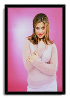 Danielle Fishel framed wall art print presents her pink-sweater portrait against a rosy gradient in a black mitered frame.