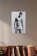 David Beckham in a cozy movie room above a brown sofa with popcorn.
