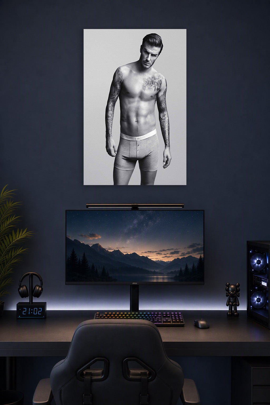 David Beckham in a gaming desk setup above a monitor.