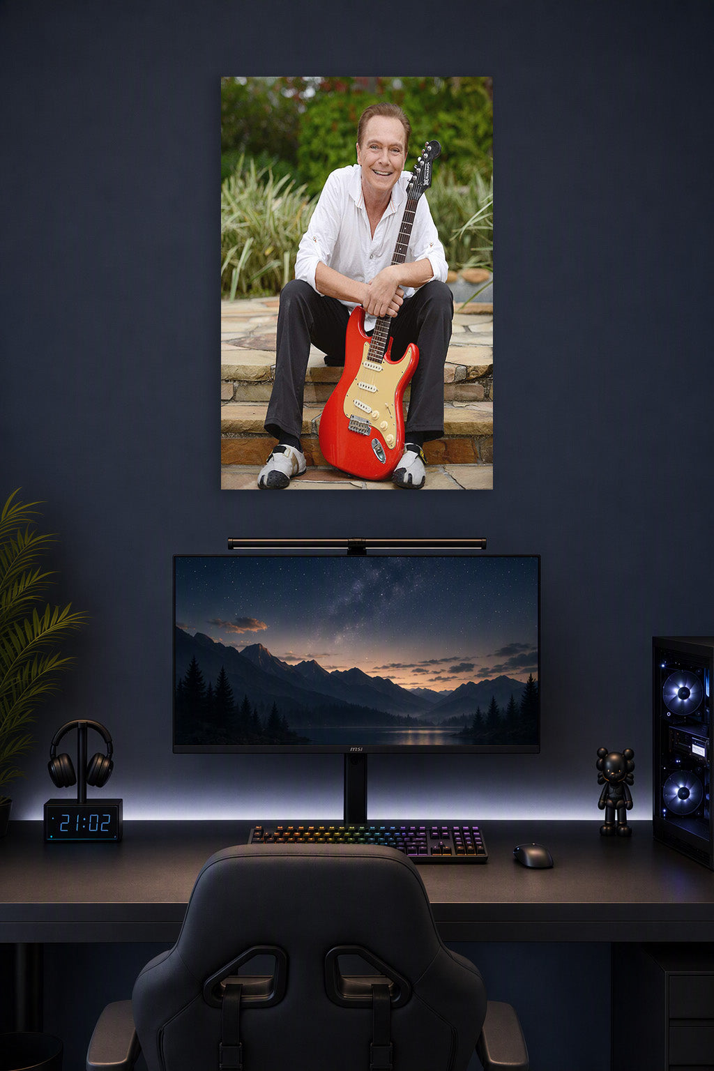 David Cassidy in a gaming desk setup above a monitor.