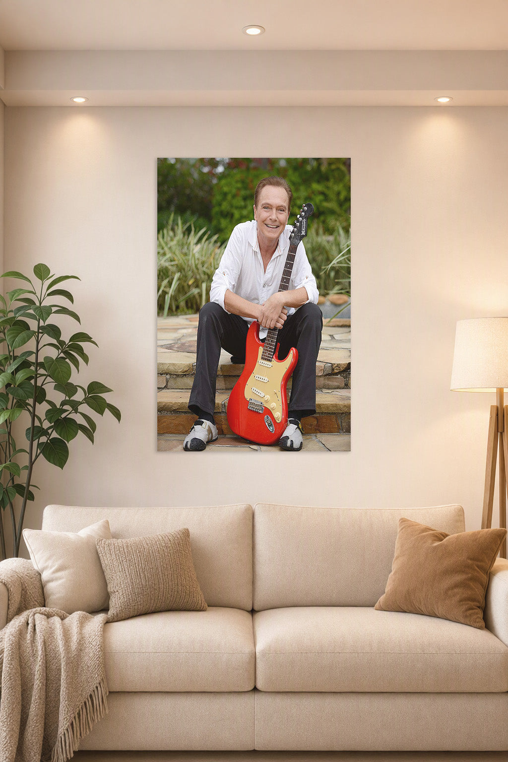 David Cassidy in a bright living room above a beige sofa.