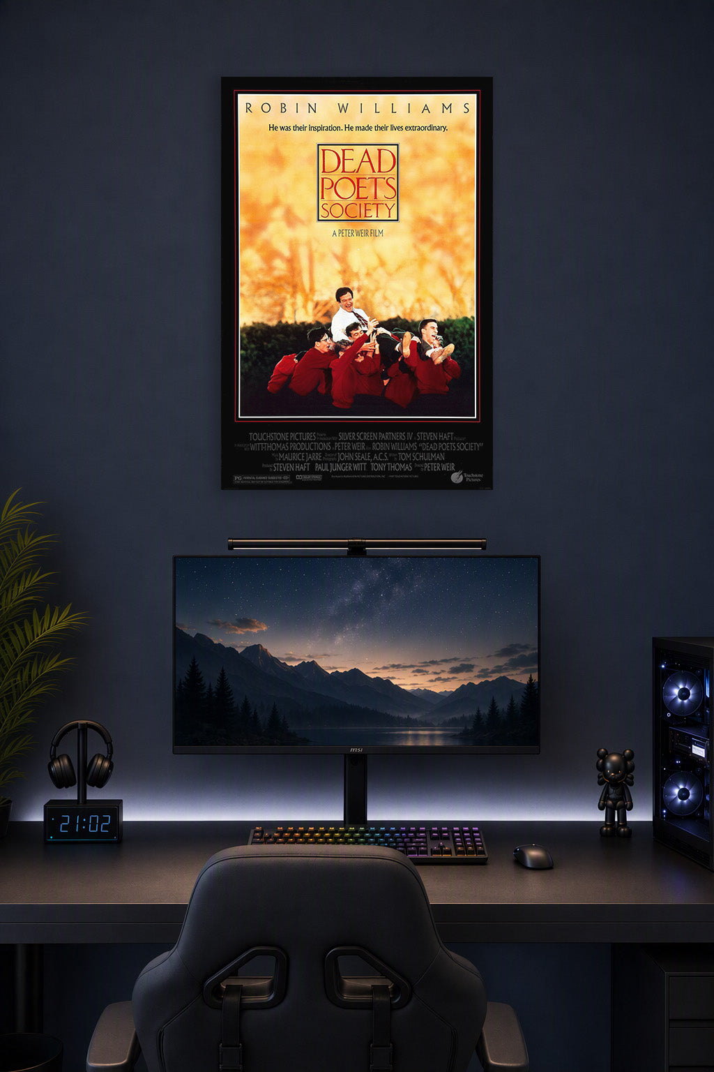 Dead Poets Society Robin Williams in a gaming desk setup above a monitor.