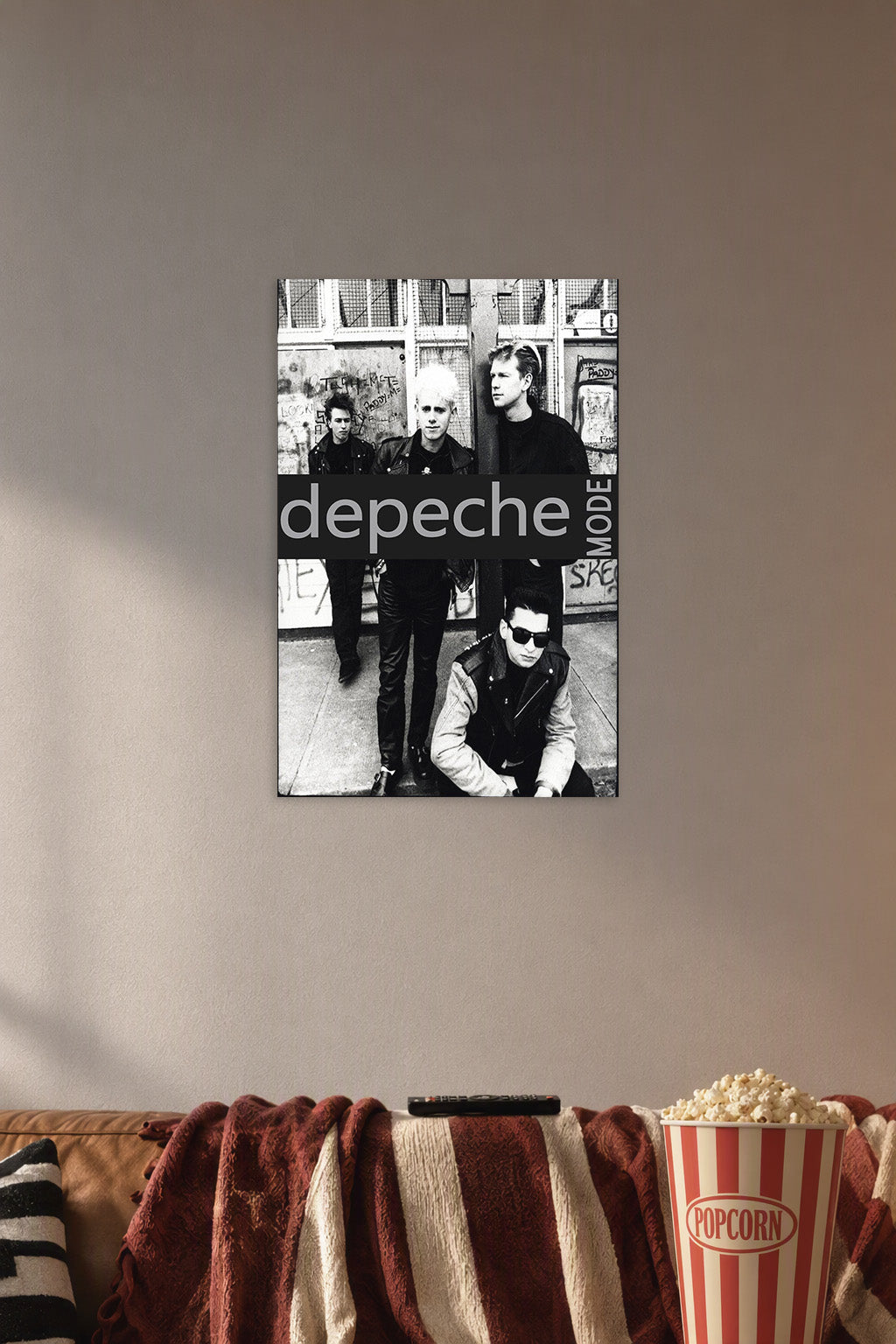Depeche Mode in a cozy movie room above a brown sofa with popcorn.