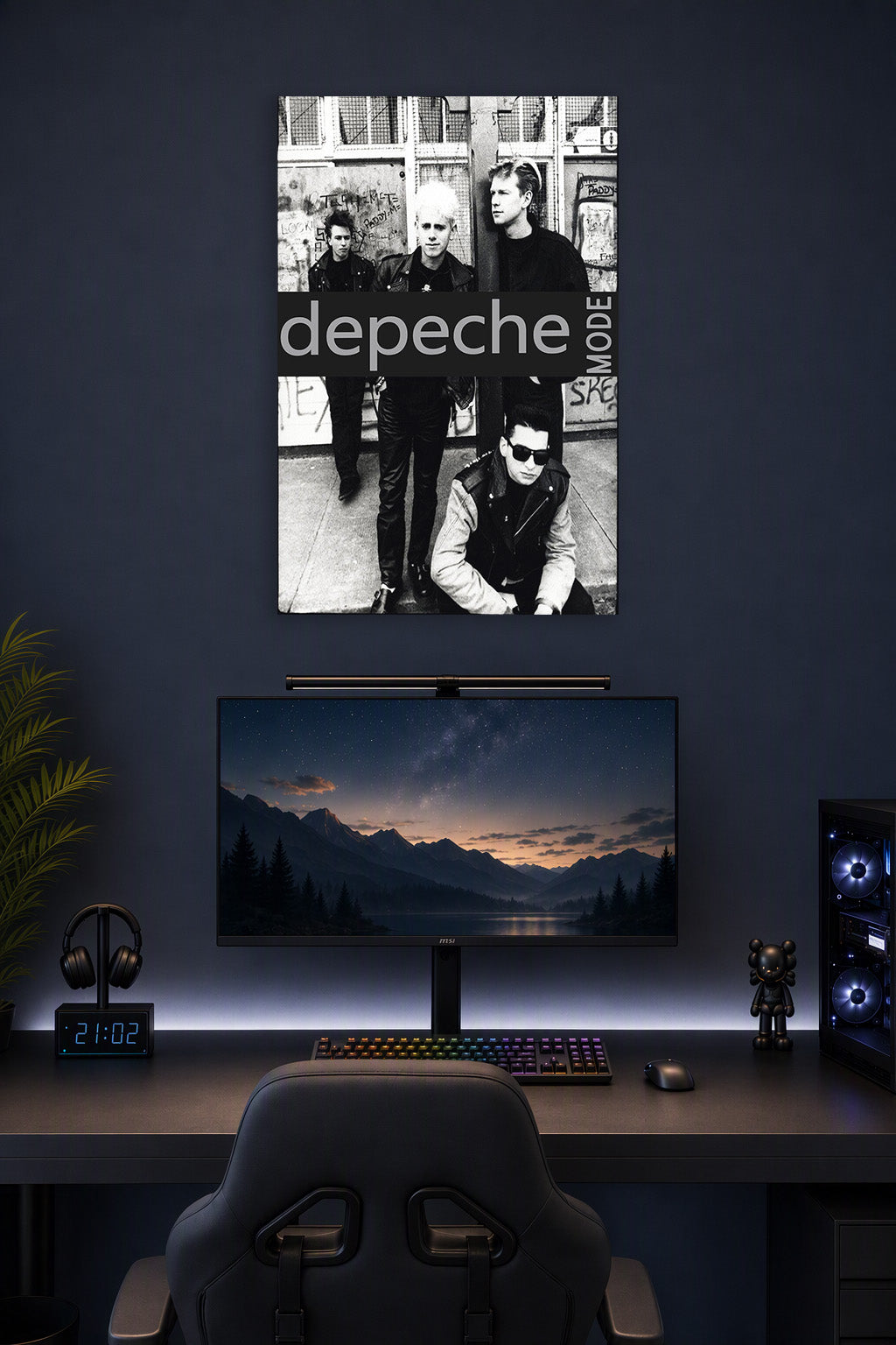 Depeche Mode in a gaming desk setup above a monitor.