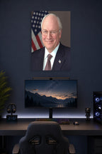 Dick Cheney in a gaming desk setup above a monitor.