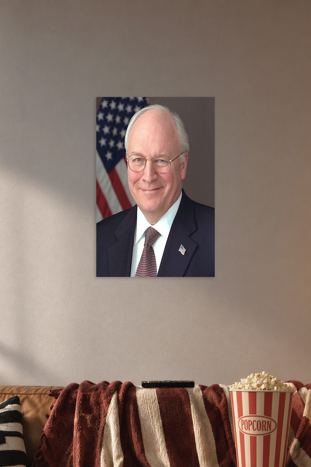 Dick Cheney in a cozy movie room above a brown sofa with popcorn.