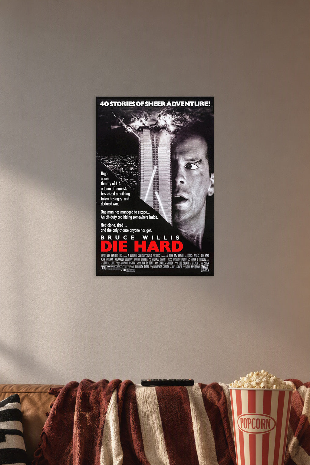Die Hard Movie Poster in a cozy movie room above a brown sofa with popcorn.
