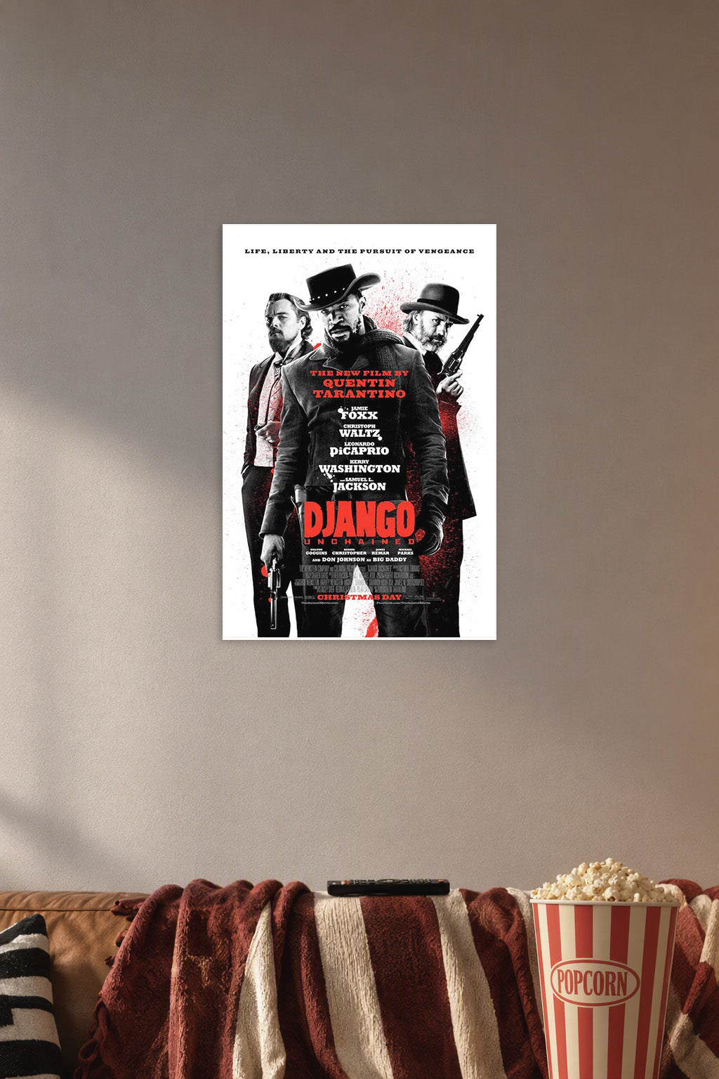 Django Unchained Movie Poster in a cozy movie room above a brown sofa with popcorn.