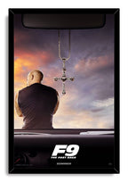 Dominick Toretto F9 framed wall art print with a black border, car interior, hanging cross necklace, and dramatic sunset clouds.