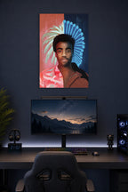 Donald Glover / Childish Gambino in a gaming desk setup above a monitor.