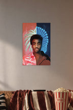 Donald Glover / Childish Gambino in a cozy movie room above a brown sofa with popcorn.