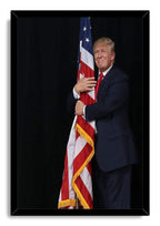 Donald Trump framed wall art print features him holding a gold-fringed American flag while dressed in a navy suit and red tie.