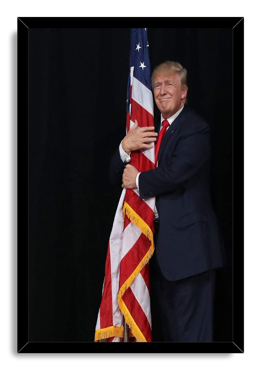 Donald Trump framed wall art print features him holding a gold-fringed American flag while dressed in a navy suit and red tie.