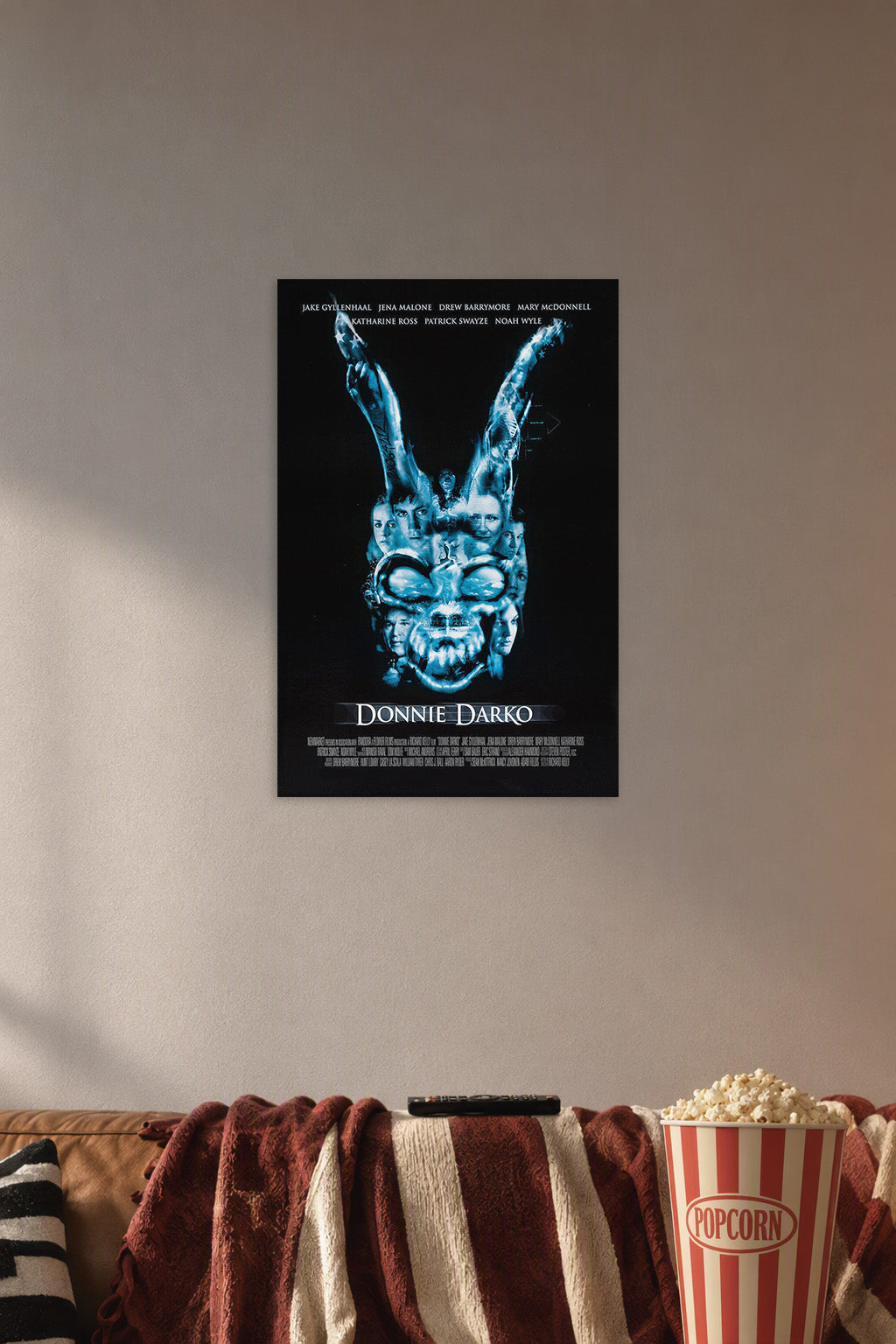 Donnie Darko Movies in a cozy movie room above a brown sofa with popcorn.