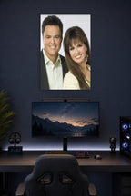 Donny & Marie Osmond in a gaming desk setup above a monitor.