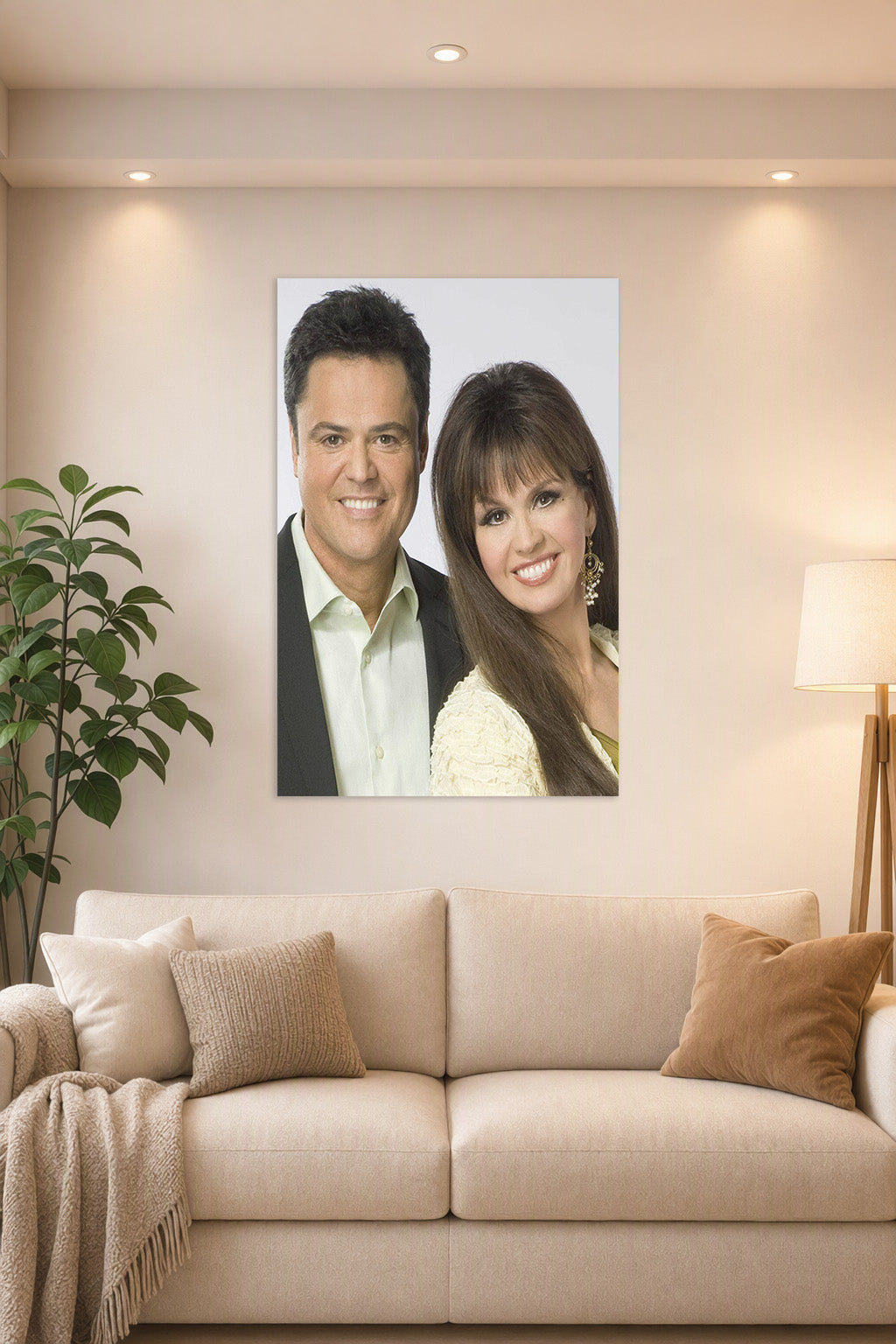 Donny & Marie Osmond in a bright living room above a beige sofa.