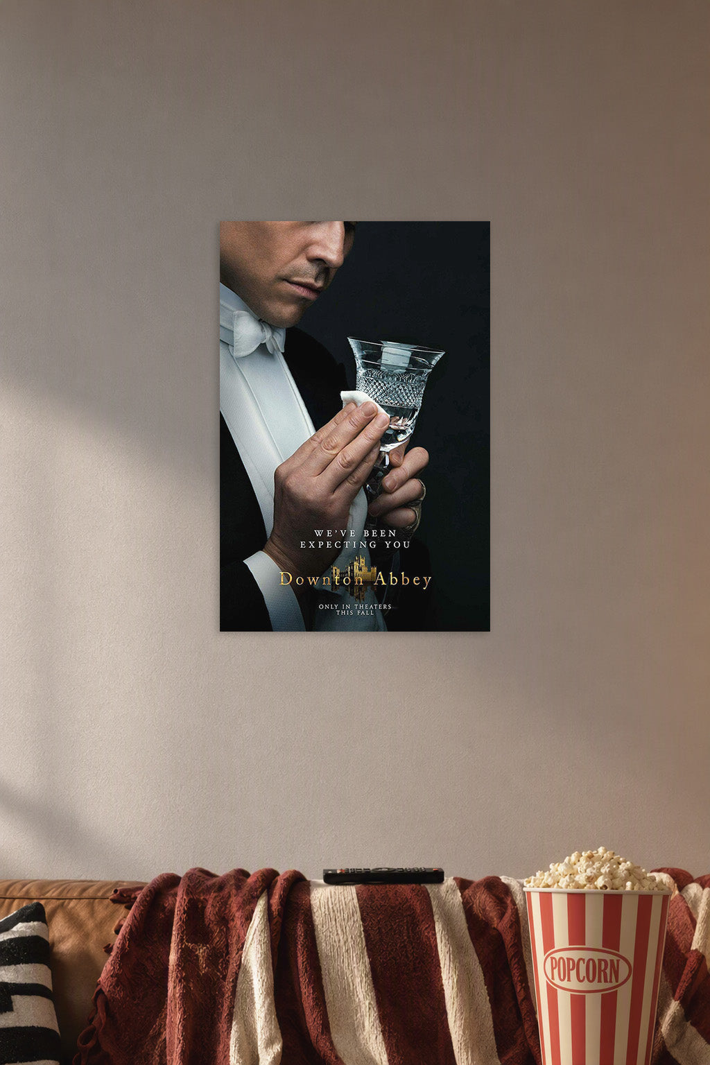 Downton Abbey Butler in a cozy movie room above a brown sofa with popcorn.
