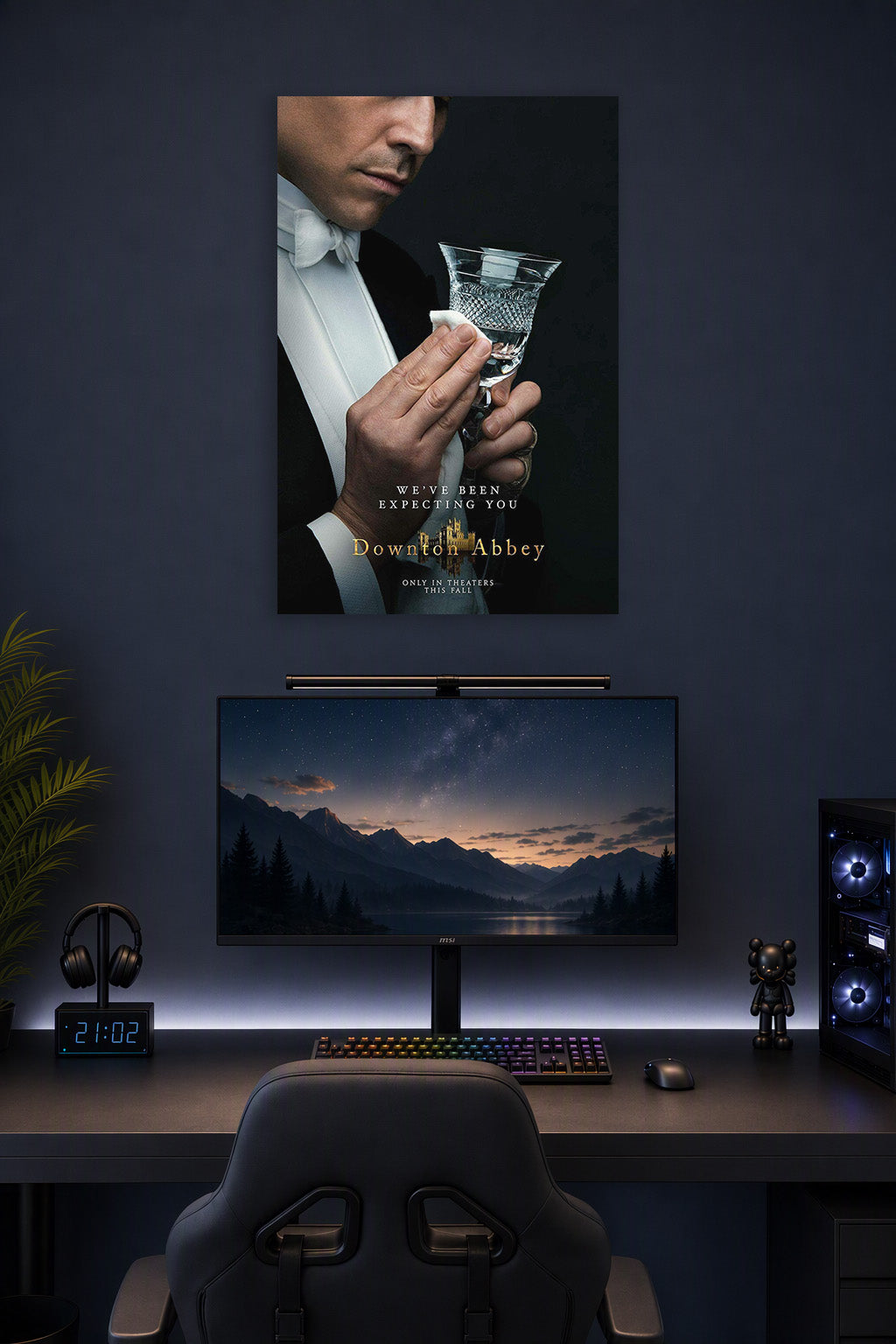 Downton Abbey Butler in a gaming desk setup above a monitor.