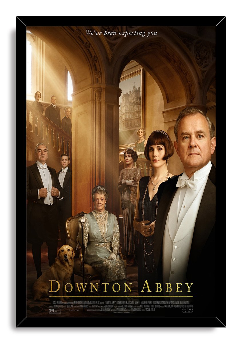 Downton Abbey framed wall art print shows the formal cast, a seated elderly woman, and golden dog in a grand hall.