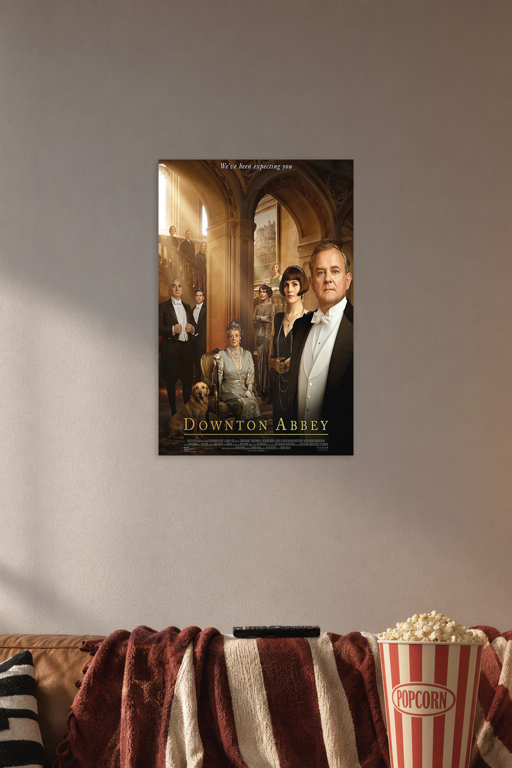 Downton Abbey in a cozy movie room above a brown sofa with popcorn.