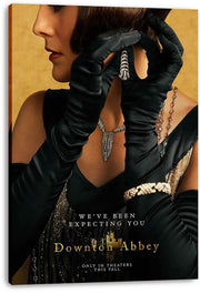 Downton Abbey canvas wall art print displays a gloved woman in a black gown with silver jewelry on a warm gold background.
