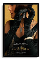 Downton Abbey framed wall art print features a woman in black gloves and jeweled accessories, bordered by a black frame.
