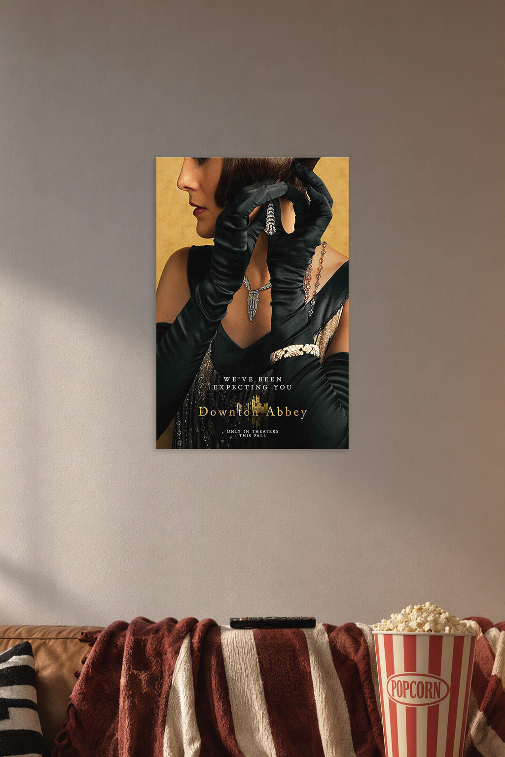 Downton Abbey Elegant Woman in a cozy movie room above a brown sofa with popcorn.