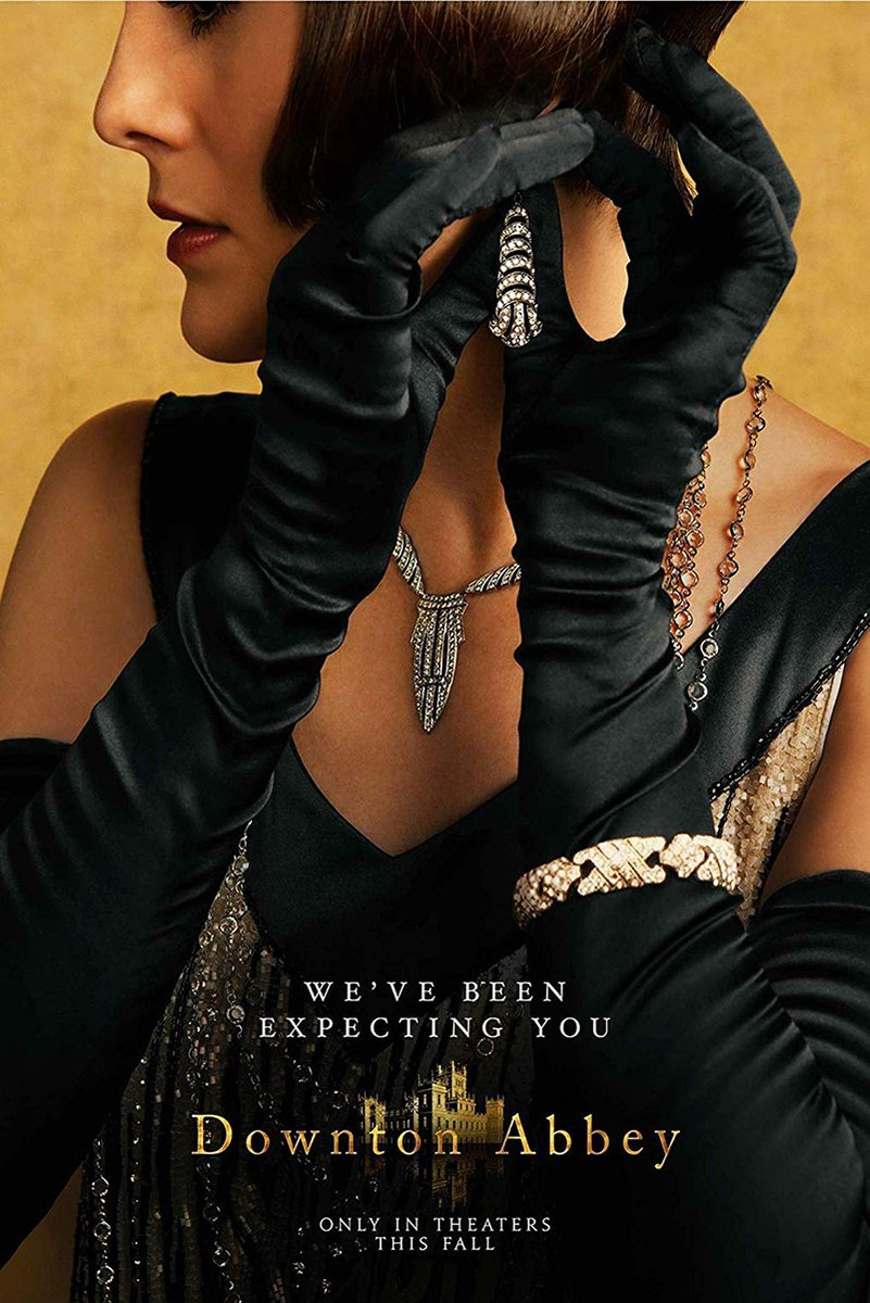 Downton Abbey poster features a woman in black satin gloves and a dark gown holding a jeweled earring against gold.