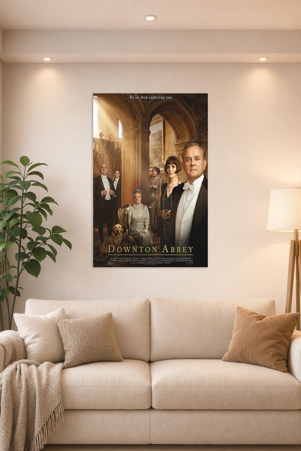 Downton Abbey Movie Poster in a bright living room above a beige sofa.