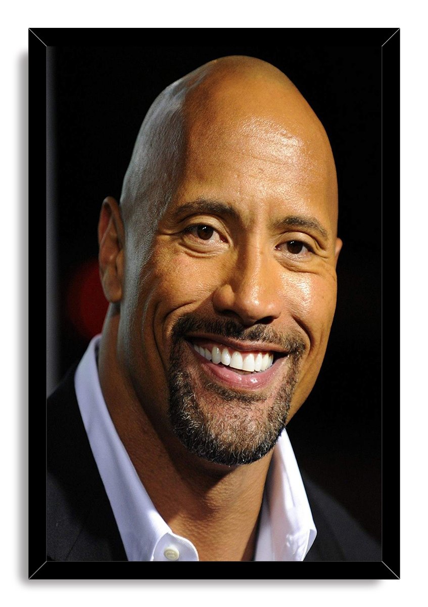 Dwayne The Rock Johnson framed wall art print displays his warm smiling portrait in a black frame, wearing a dark jacket and white shirt.