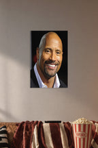 Dwayne 'The Rock' Johnson in a cozy movie room above a brown sofa with popcorn.