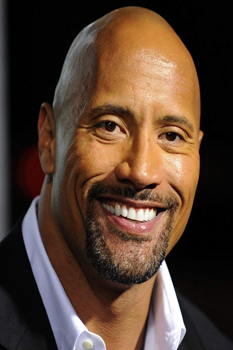Dwayne The Rock Johnson poster features a close-up smiling portrait in a black jacket and open white shirt against black.