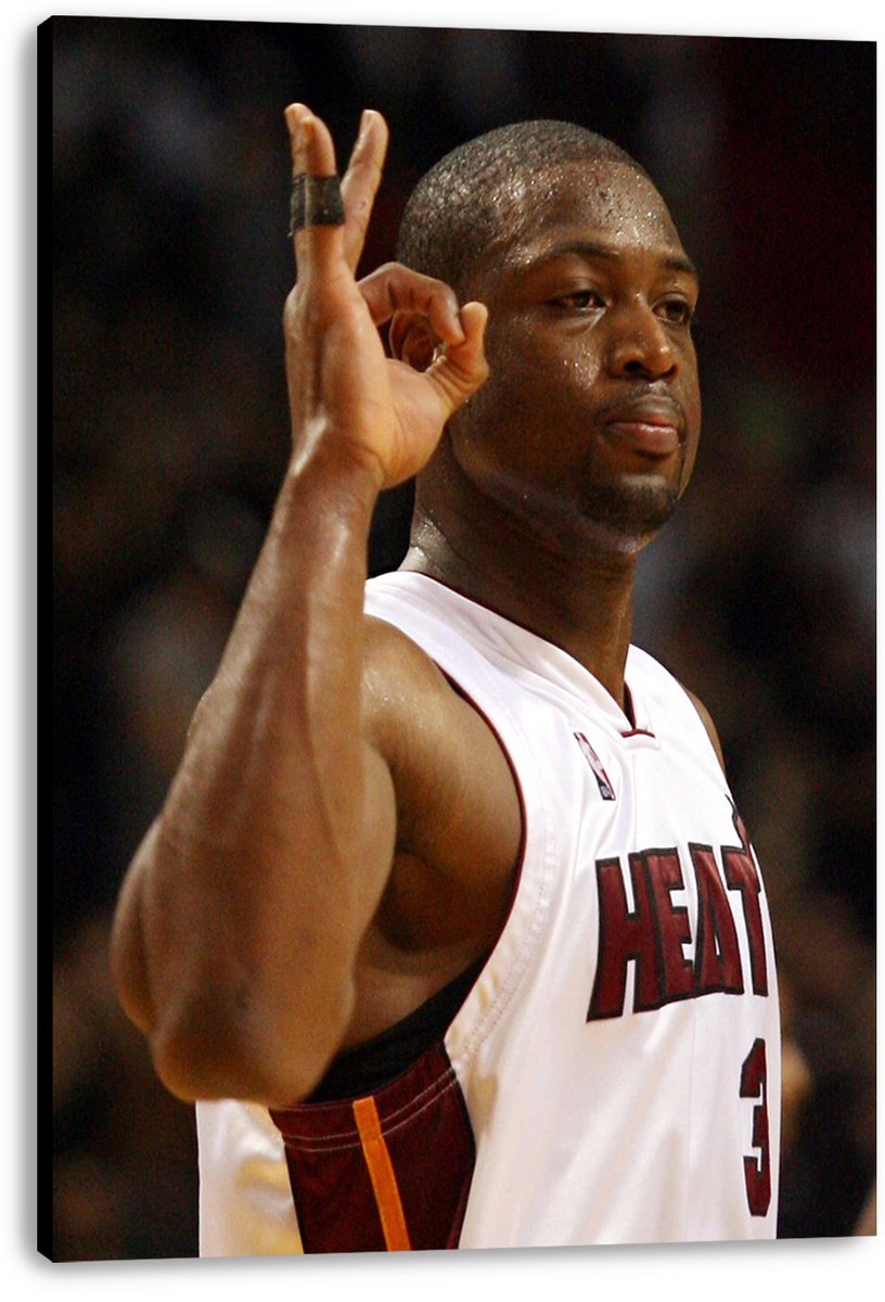 Dwyane Wade canvas wall art print displays the Miami Heat guard in a white number 3 jersey against a blurred arena background.