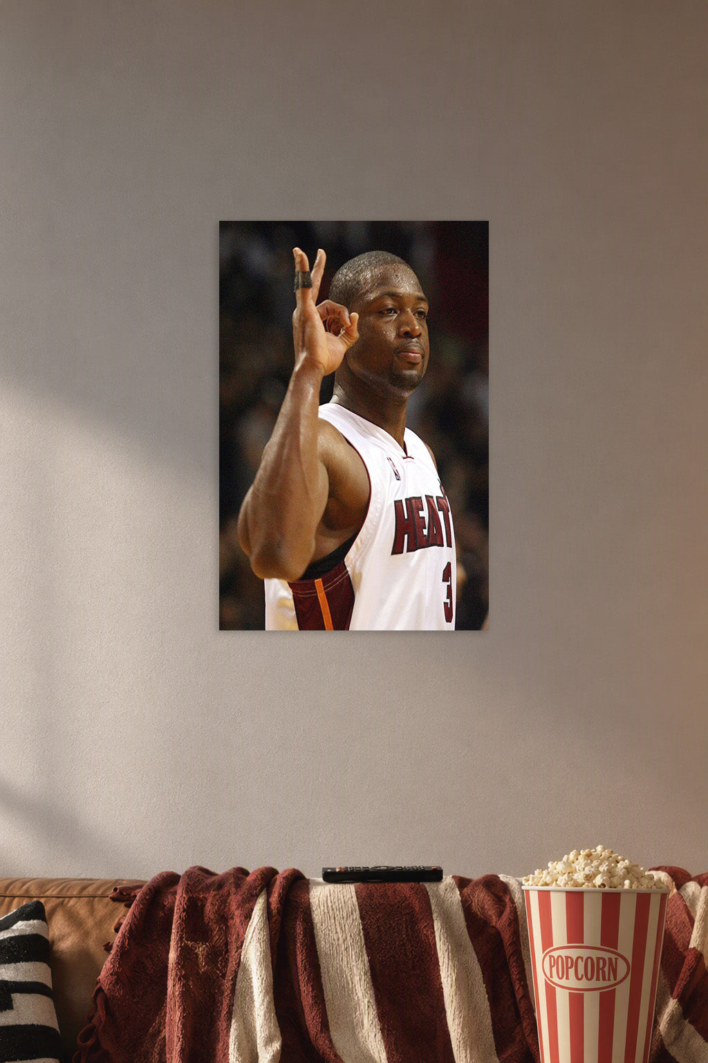 Dwyane Wade in a cozy movie room above a brown sofa with popcorn.