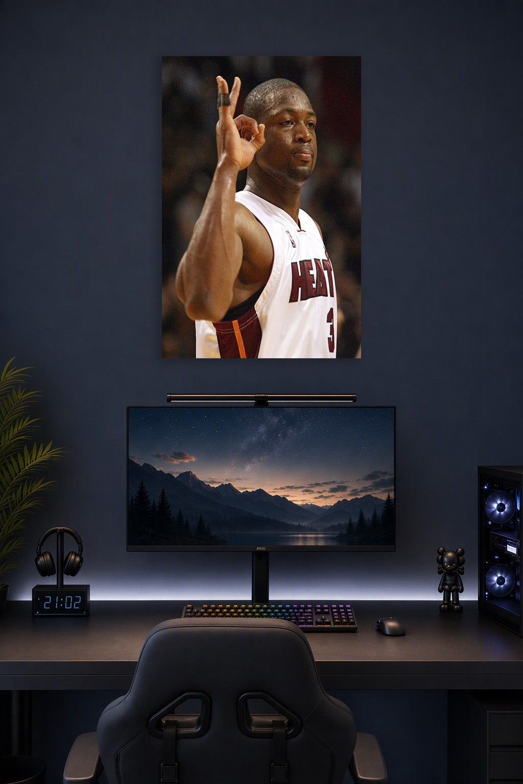 Dwyane Wade in a gaming desk setup above a monitor.