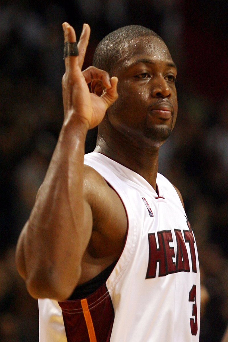 Dwyane Wade poster features the Miami Heat player in a white number 3 jersey raising an OK hand gesture on court.