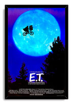 E.T. The Extra-Terrestrial framed wall art print with a black border, luminous blue moon, flying bicycle silhouette, and dark treetops.