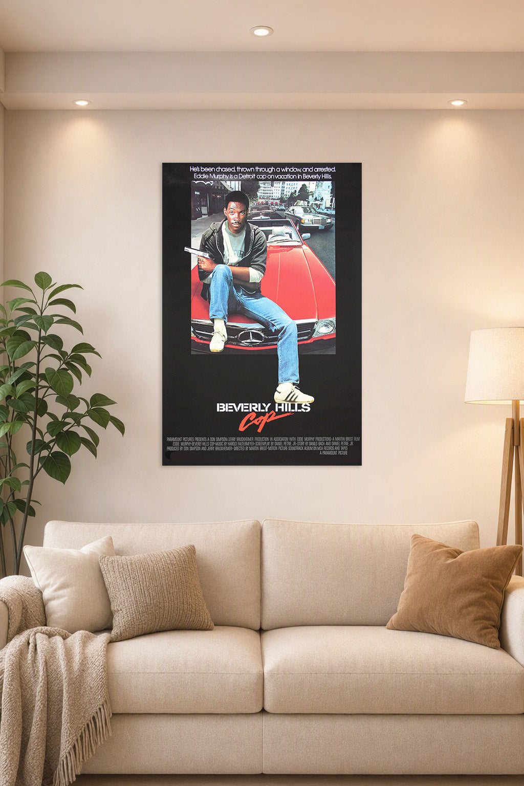 Eddie Murphy Beverly Hills Cop in a bright living room above a beige sofa.