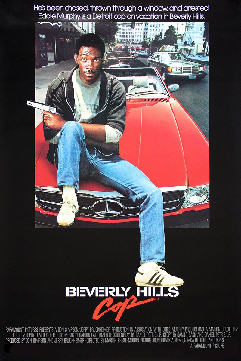 Beverly Hills Cop poster features Eddie Murphy seated on a red Mercedes with a pistol, city traffic, and a black title panel.