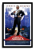 Framed Coming to America wall art print with Eddie Murphy as Prince Akeem, city towers, glowing traffic, and red title text.