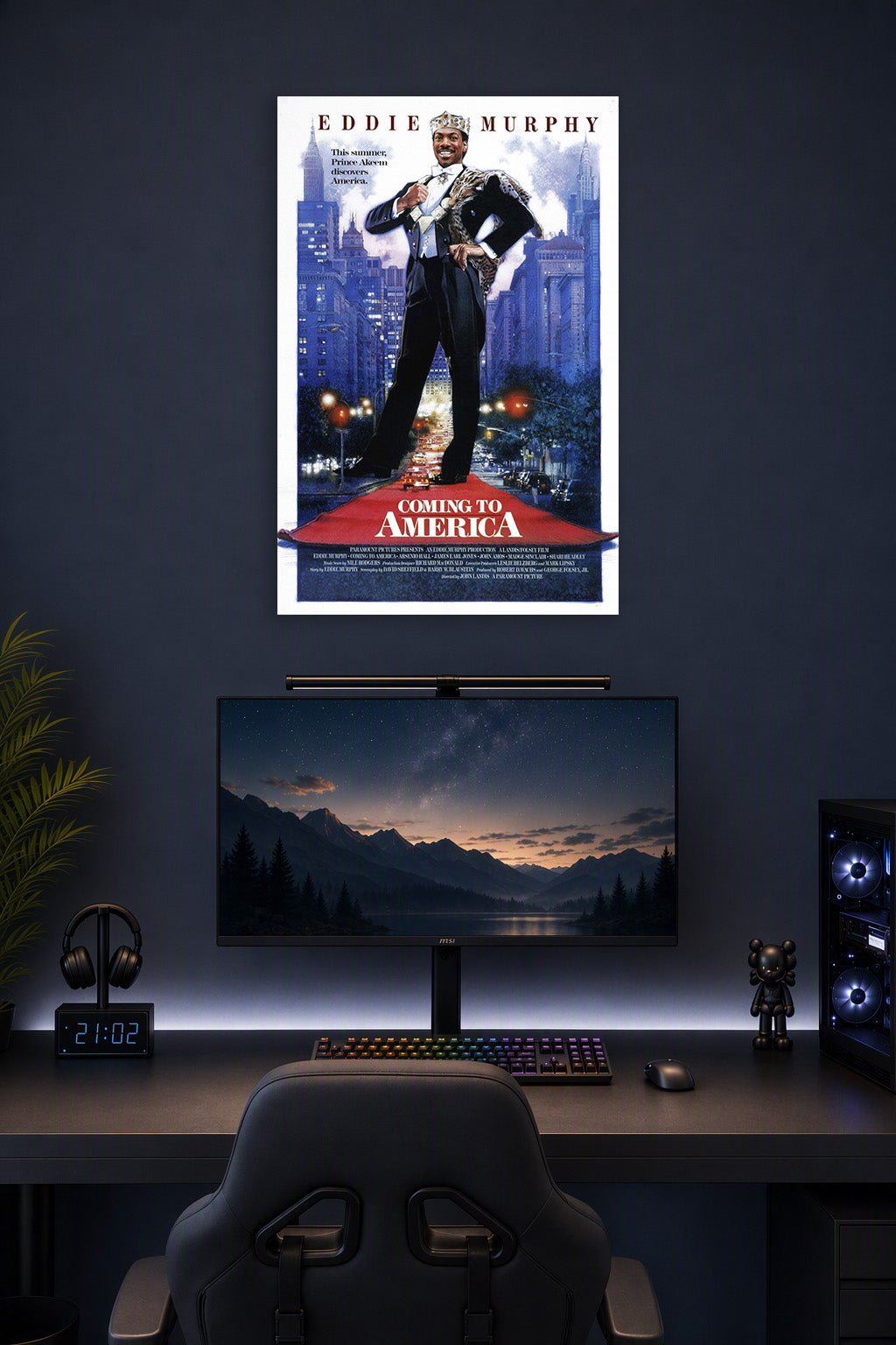 Eddie Murphy Prince Akeem Coming to America in a gaming desk setup above a monitor.