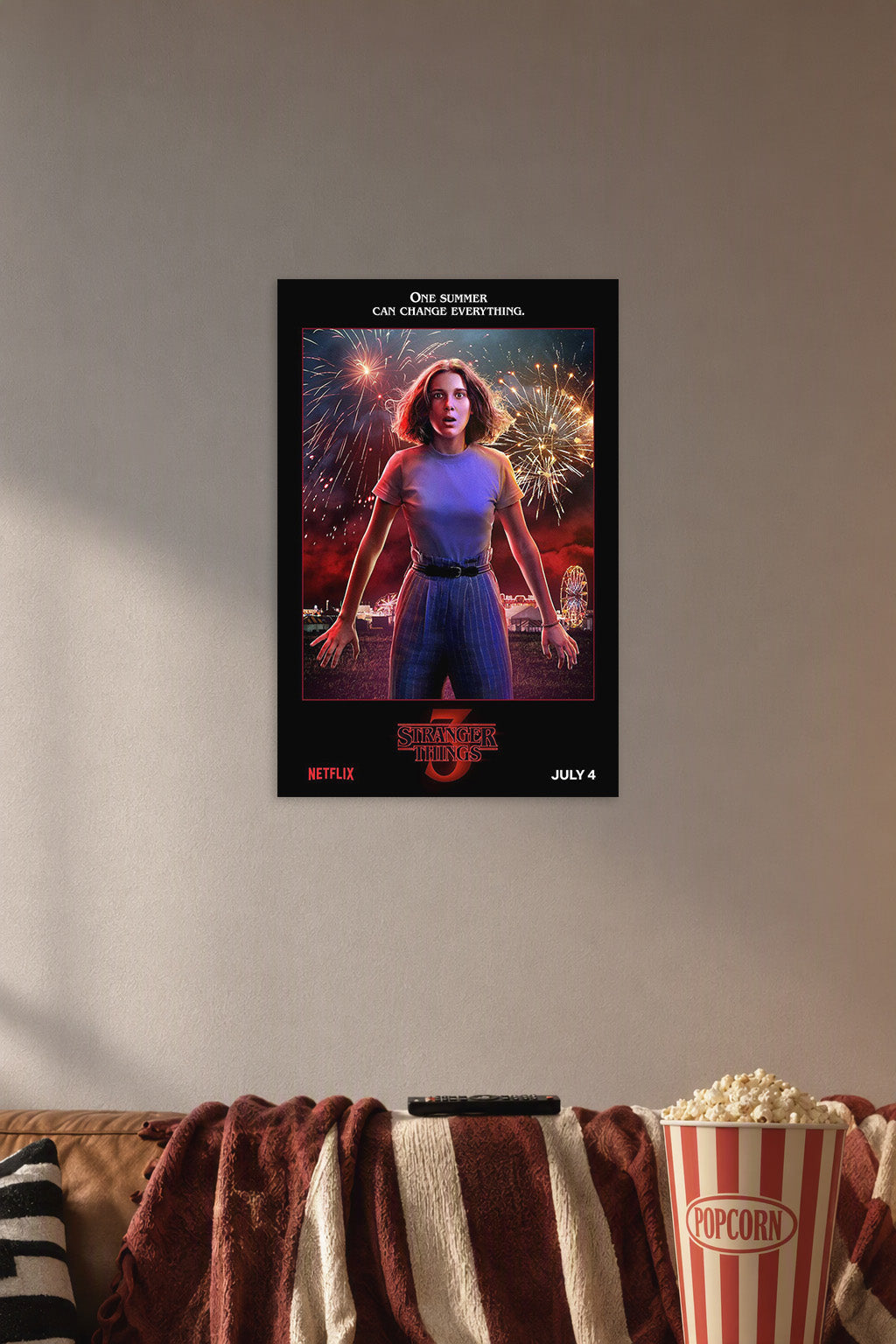 Eleven Stranger Things Fireworks in a cozy movie room above a brown sofa with popcorn.