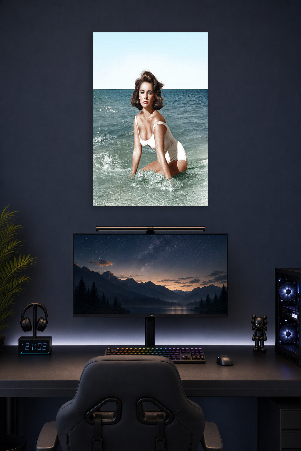 Elizabeth Taylor in a gaming desk setup above a monitor.