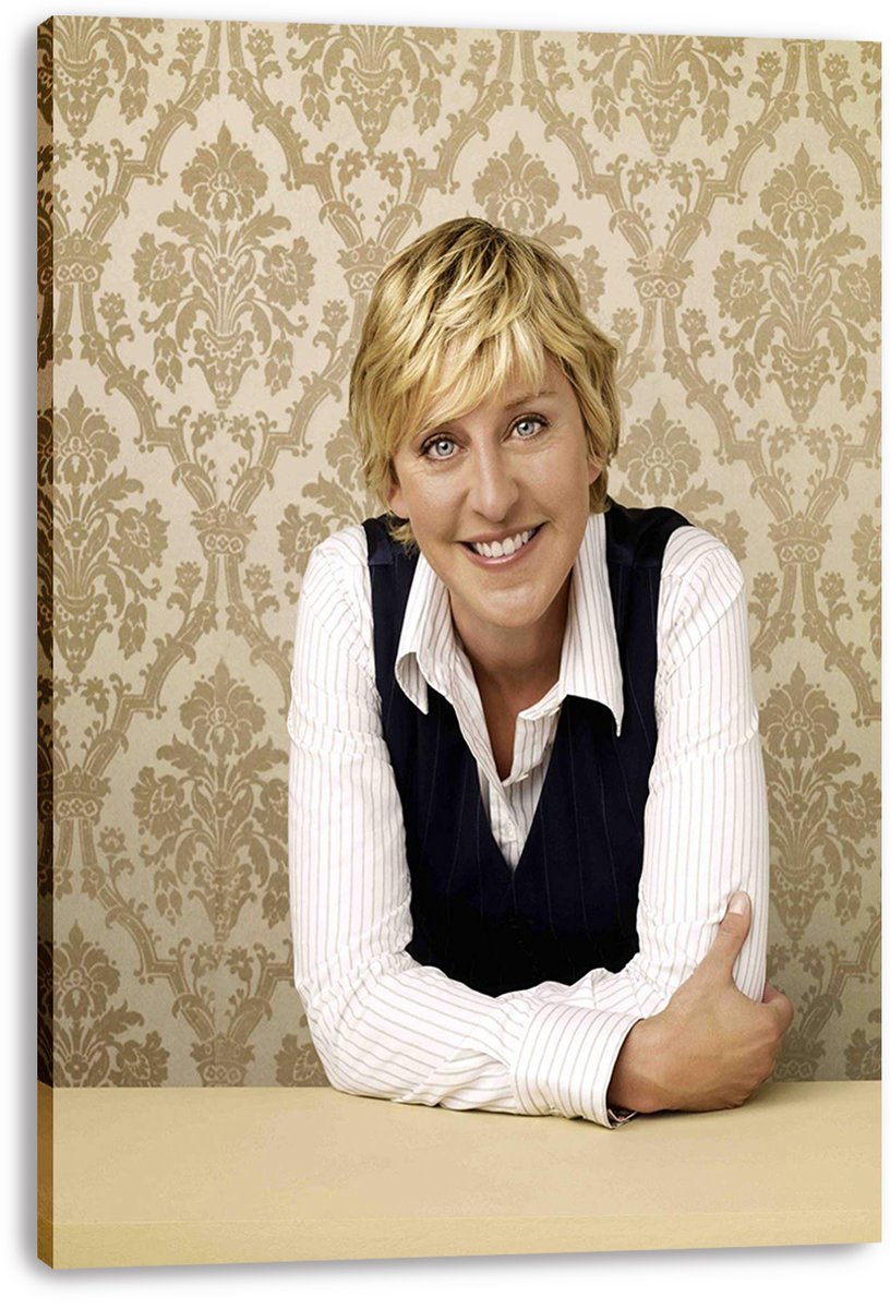 Ellen DeGeneres canvas wall art print featuring her smiling in a striped white shirt and dark vest against ornate beige wallpaper.