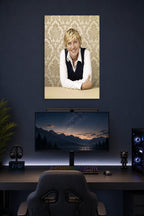 Ellen DeGeneres in a gaming desk setup above a monitor.