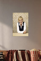 Ellen DeGeneres in a cozy movie room above a brown sofa with popcorn.